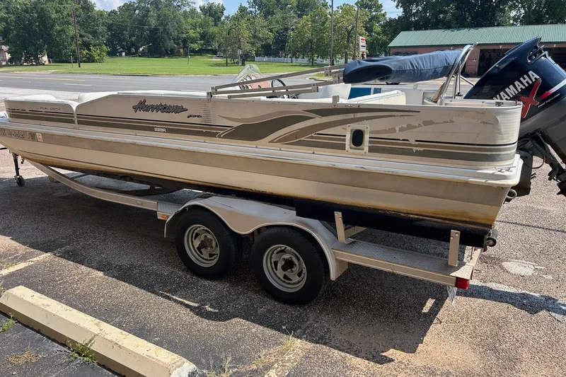 Slide: The Image of 2003 Hurricane FD228REF boat on trailer with Yamaha outboard motor, parked outdoors. - 10