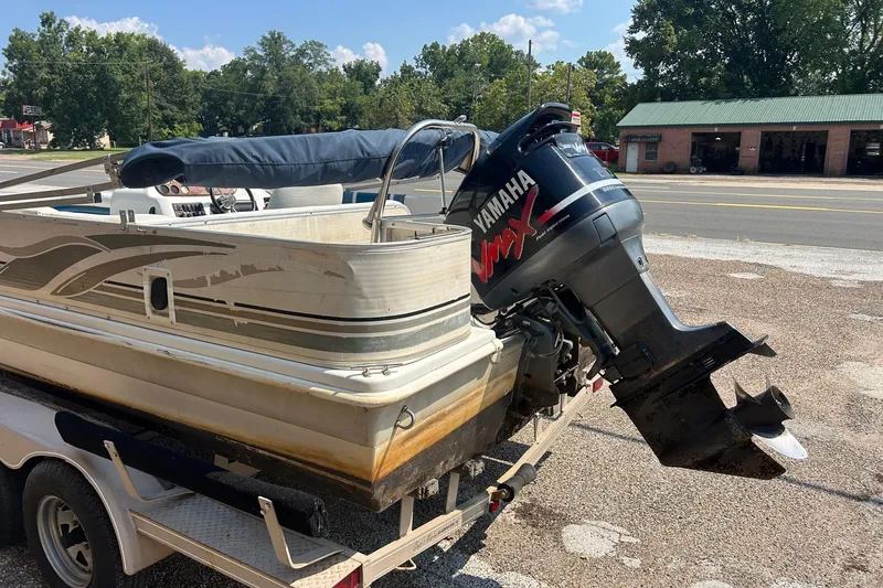 Slide: The Image of 2003 Hurricane FD228REF boat with Yamaha outboard motor on trailer, parked roadside. - 11