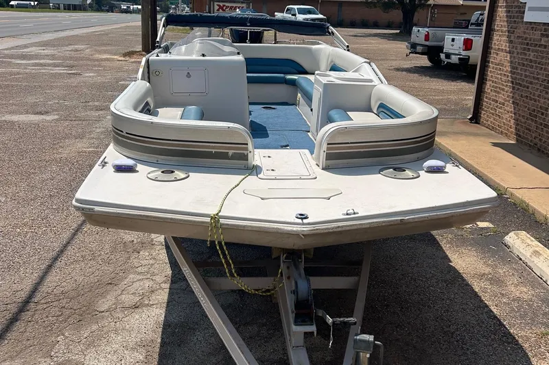 Slide: The Image of 2003 Hurricane FD228REF boat on trailer, parked on roadside. - 2