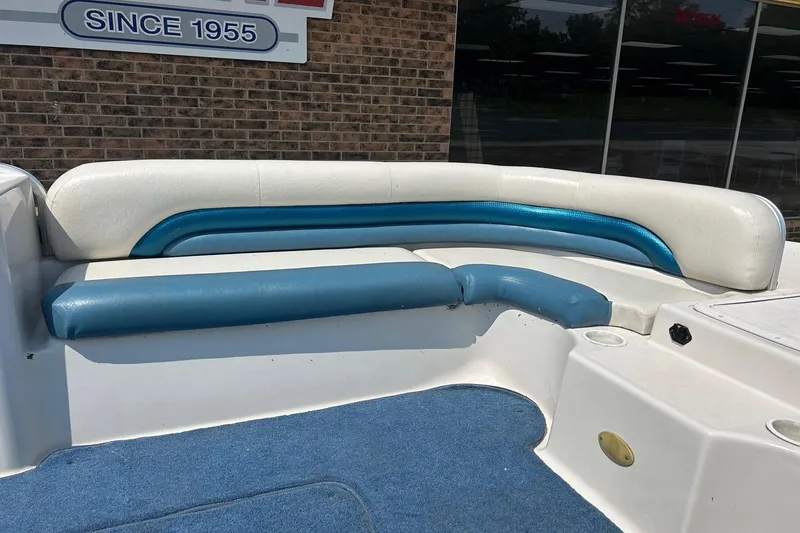 Slide: The Image of 2003 Hurricane FD228REF boat seating with blue and white upholstery, outdoor setting. - 5