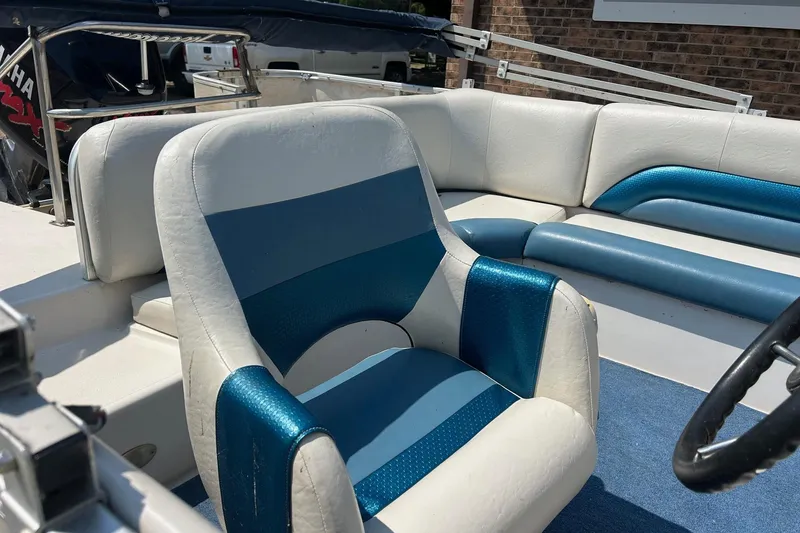 Slide: The Image of 2003 Hurricane FD228REF boat interior with blue and white seating and steering wheel. - 6