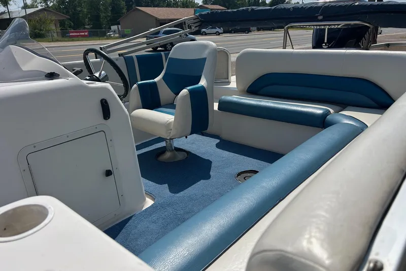 Slide: The Image of Interior of a 2003 Hurricane FD228REF boat with blue and white seating. - 7