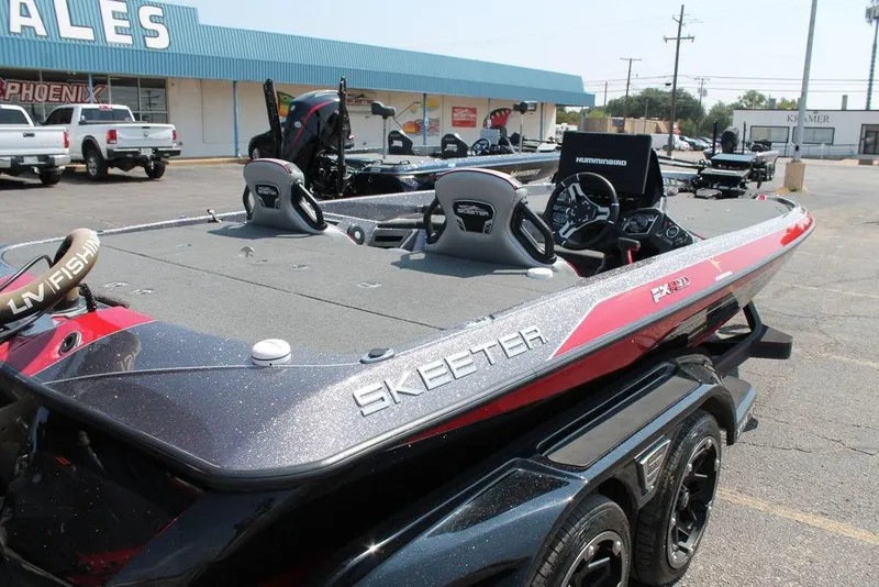 Slide: The Image of 2022 Skeeter FXR21 Apex bass boat in dealership lot, showcasing sleek design and advanced features. - 8