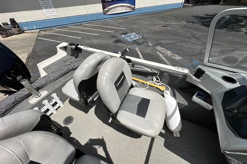 Slide: The Image of 2019 Tracker Pro Guide V-16 WT boat interior with gray seating and control panel. - 13