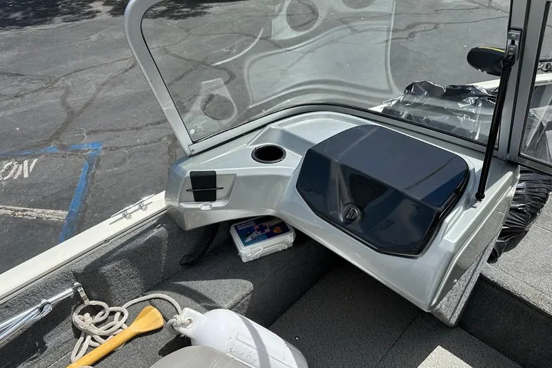 Slide: The Image of 2019 Tracker Pro Guide V-16 WT boat interior with windshield, storage, and safety equipment. - 14