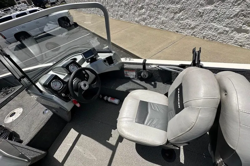 Slide: The Image of 2019 Tracker Pro Guide V-16 WT boat interior with steering wheel and seats. - 18