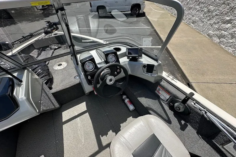 Slide: The Image of 2019 Tracker Pro Guide V-16 WT boat interior with steering wheel and dashboard controls. - 19
