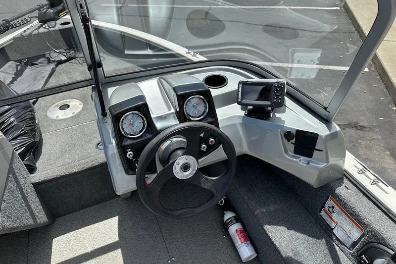 Slide: The Image of 2019 Tracker Pro Guide V-16 WT boat dashboard with steering wheel and navigation system. - 20