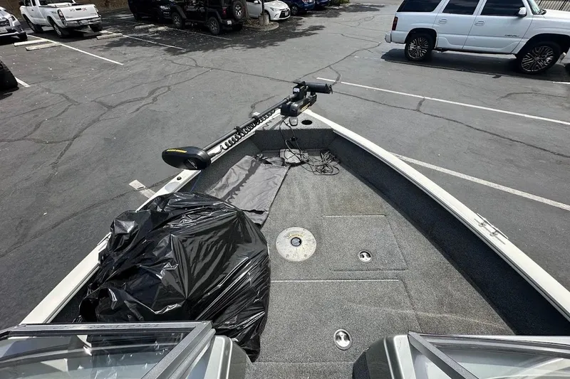 Slide: The Image of 2019 Tracker Pro Guide V-16 WT boat in parking lot, featuring trolling motor. - 24