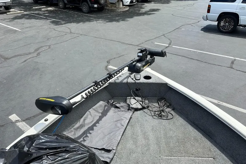 Slide: The Image of 2019 Tracker Pro Guide V-16 WT boat with trolling motor in parking lot. - 25