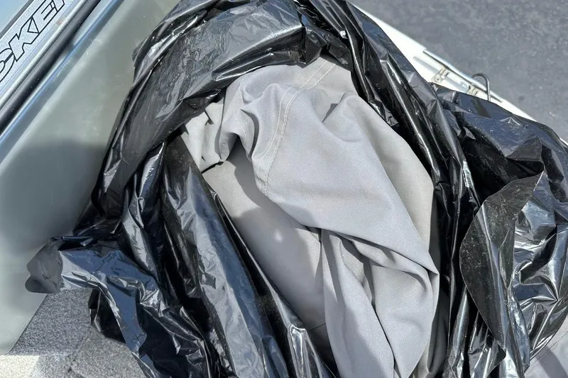 Slide: The Image of Black bag with gray fabric inside on a 2019 Tracker Pro Guide V-16 WT boat. - 27