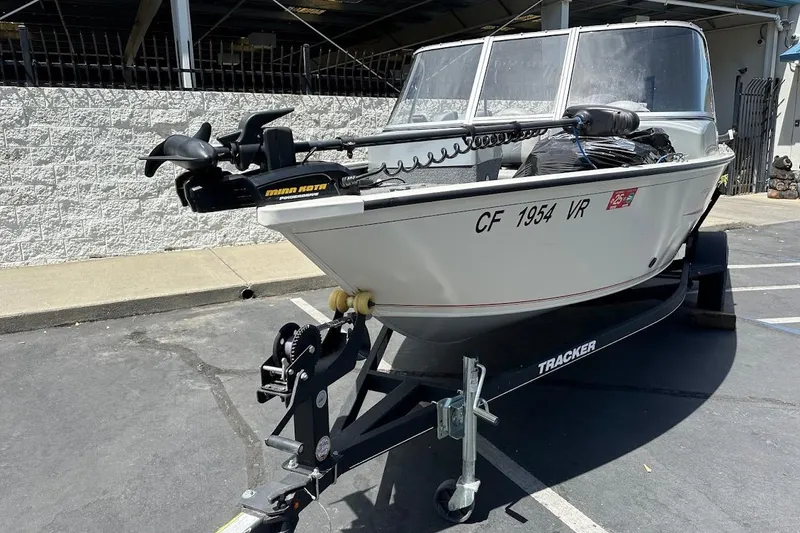 Slide: The Image of 2019 Tracker Pro Guide V-16 WT boat on trailer, parked outdoors. - 4