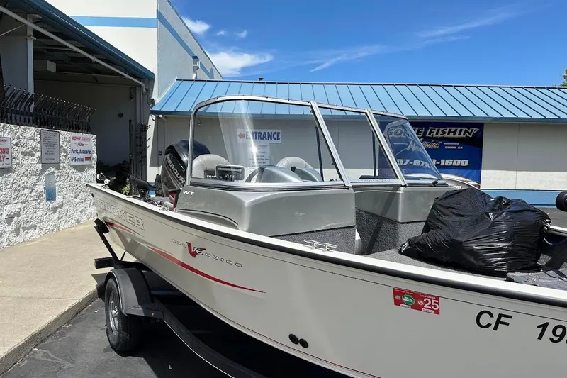 Slide: The Image of 2019 Tracker Pro Guide V-16 WT boat on trailer outside a building. - 6