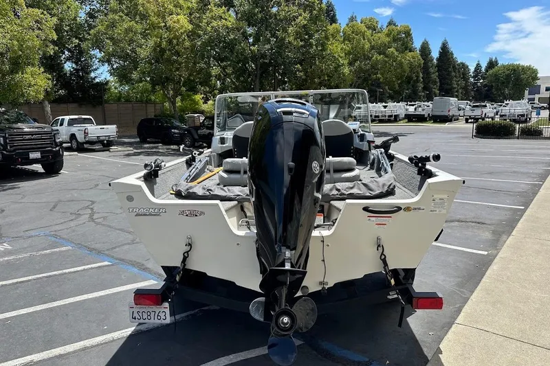 Slide: The Image of 2019 Tracker Pro Guide V-16 WT boat in parking lot, rear view with motor. - 7