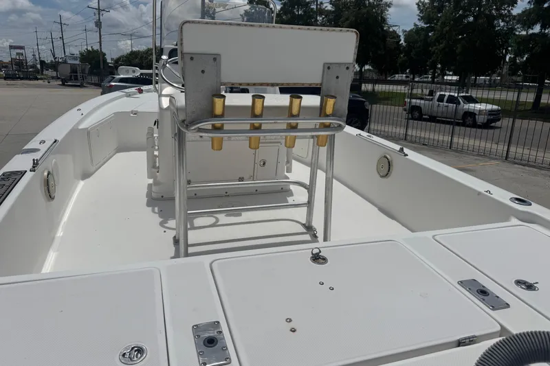 Slide: The Image of 2008 Century 2202 BAY boat with seating and rod holders, displayed outdoors. - 11