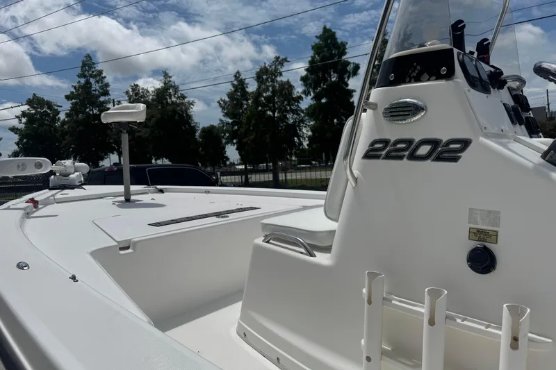 Slide: The Image of 2008 Century 2202 BAY boat console with steering wheel, gauges, and controls under a clear sky. - 14