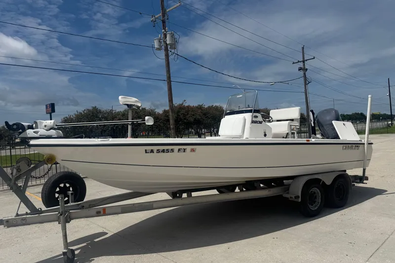 Slide: The Image of 2008 Century 2202 BAY boat on trailer, parked outside dealership with American flag. - 3