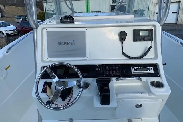 Slide: The Image of 2009 Sailfish 2360 CC boat console with Garmin navigation and steering wheel. - 3
