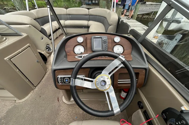 Slide: The Image of 2010 Premier 250 S-Series boat dashboard with steering wheel and control panel. - 11