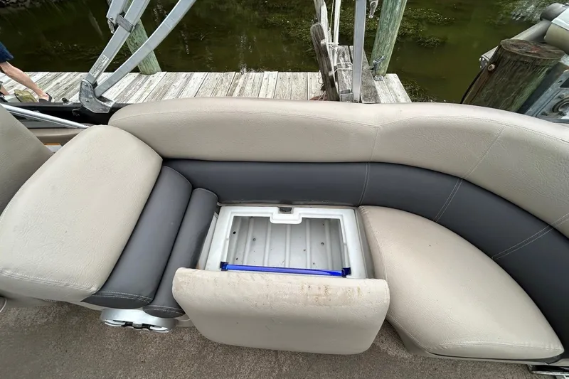 Slide: The Image of Premier 250 S-Series 2010 boat seat with storage compartment, dockside view. - 14