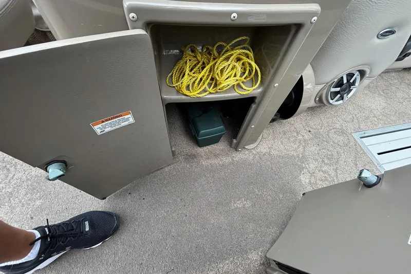 Slide: The Image of Open storage compartment on 2010 Premier 250 S-Series boat with yellow rope inside. - 16