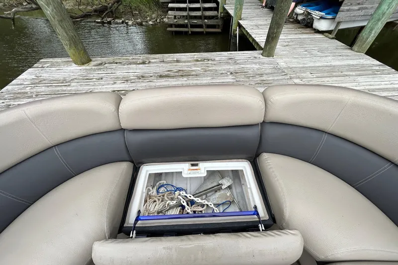Slide: The Image of Premier 250 S-Series 2010 boat with open storage compartment at dockside. - 19
