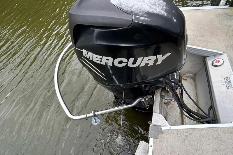 Slide: The Image of Outboard motor on 2013 Premier 250 S-Series boat, docked on water. - 24