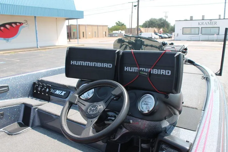 Slide: The Image of 2022 Phoenix 721 Pro XP boat dashboard with dual Humminbird displays and steering wheel. - 3