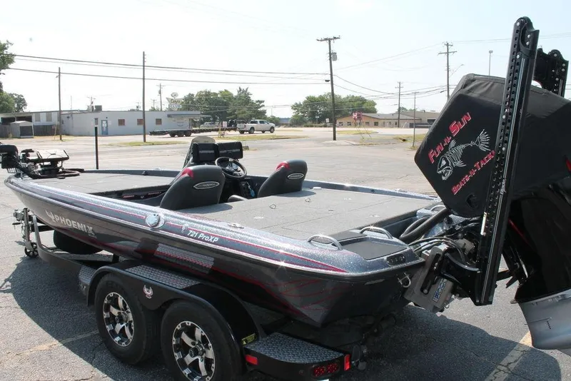 Slide: The Image of 2022 Phoenix 721 Pro XP bass boat in parking lot, showcasing sleek design and dual console. - 7
