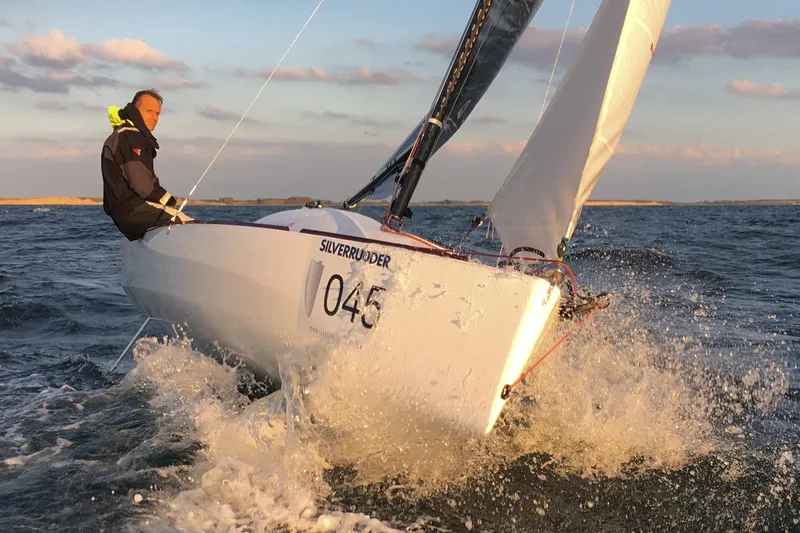 Slide: The Image of Sailing Beneteau First 18 SE 2026 in dynamic ocean waves at sunset. - 6