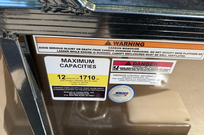 Slide: The Image of Warning and capacity labels on 2025 Tahoe Pontoon Sport 85 Rear Fish boat. - 12
