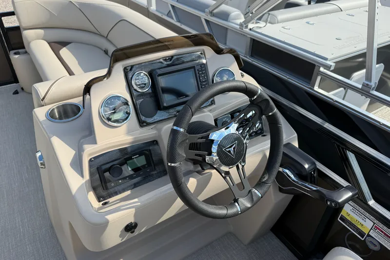 Slide: The Image of 2025 Tahoe Pontoon Sport 85 Rear Fish dashboard with steering wheel and controls. - 3