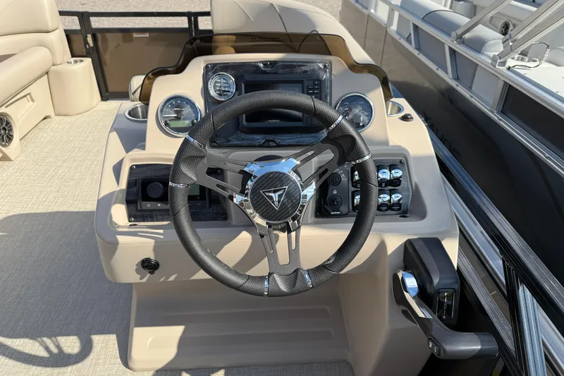 Slide: The Image of 2025 Tahoe Pontoon Sport 85 Rear Fish dashboard with steering wheel and controls. - 5