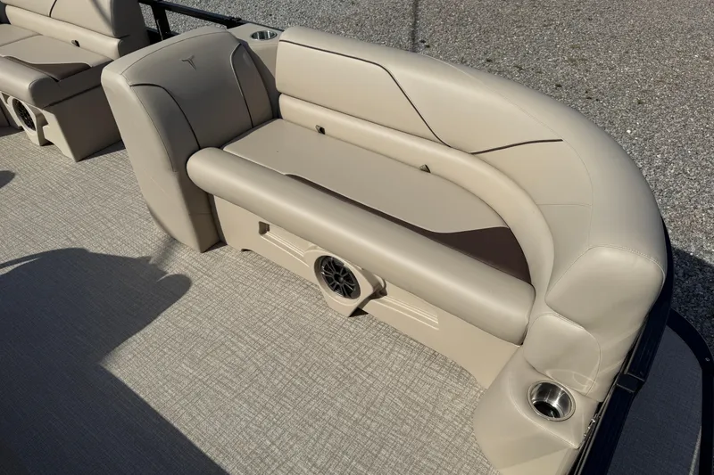 Slide: The Image of 2025 Tahoe Pontoon Sport 85 Rear Fish boat seating with beige upholstery and integrated speaker. - 7