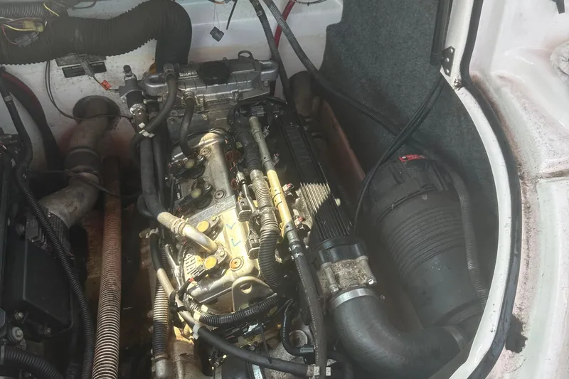 Slide: The Image of Engine compartment of a 2007 Yamaha Boats SX210, showcasing mechanical components and hoses. - 17
