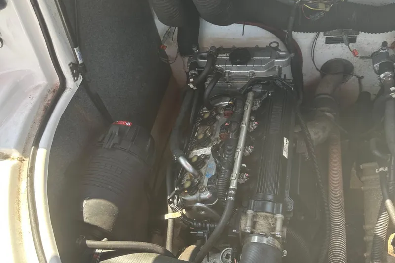 Slide: The Image of Engine compartment of a 2007 Yamaha Boats SX210, showcasing mechanical components and wiring. - 18