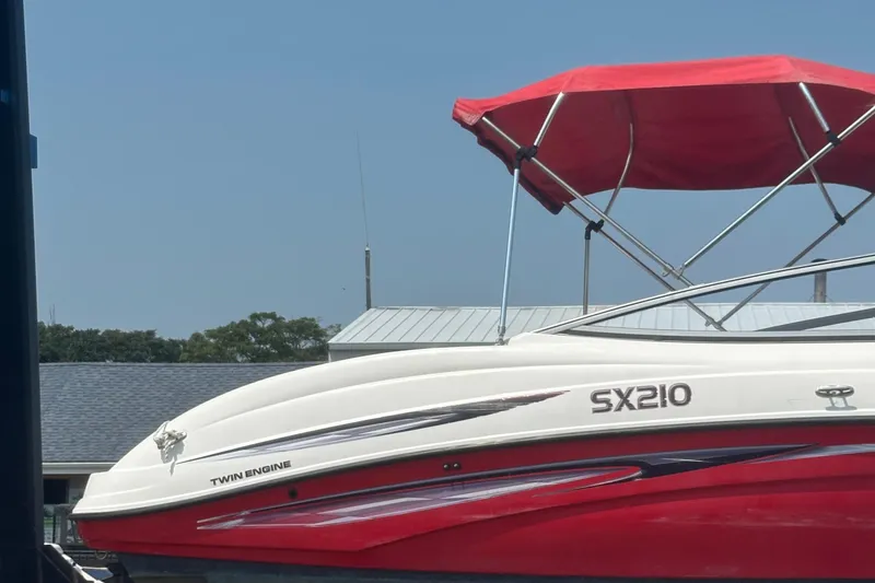 Slide: The Image of 2007 Yamaha Boats SX210 with red canopy and twin engine, docked outdoors. - 4