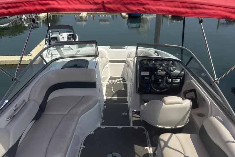 Slide: The Image of 2007 Yamaha Boats SX210 interior with red canopy, featuring seating and steering console. - 7