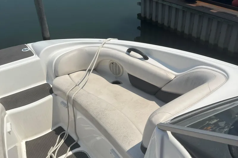 Slide: The Image of 2007 Yamaha Boats SX210 interior with white seating and docked at a marina. - 9
