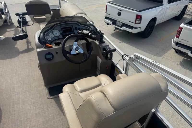 Slide: The Image of 2021 Sun Tracker Fishin' Barge 20 DLX helm with steering wheel and controls. - 13