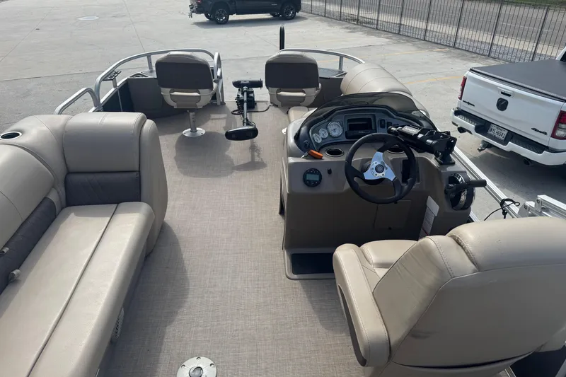 Slide: The Image of 2021 Sun Tracker Fishin' Barge 20 DLX interior with seating and steering console. - 14