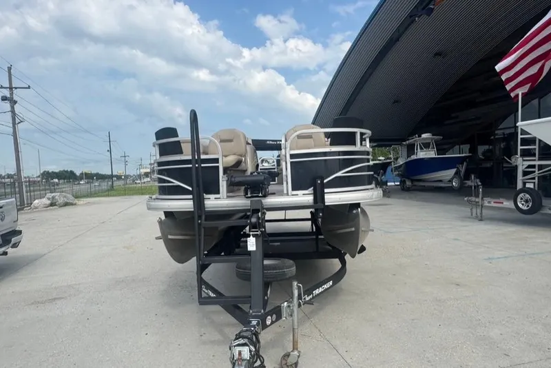Slide: The Image of 2021 Sun Tracker Fishin' Barge 20 DLX pontoon boat parked near a marina. - 3