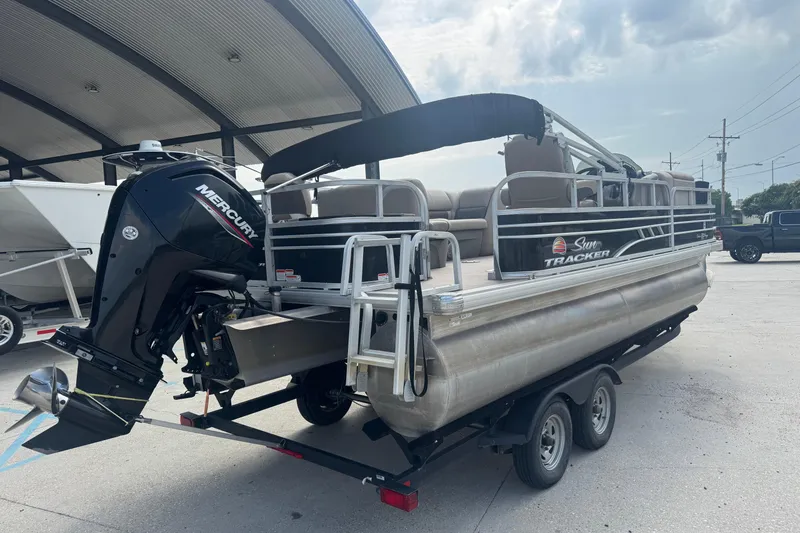 Slide: The Image of 2021 Sun Tracker Fishin' Barge 20 DLX pontoon boat with Mercury outboard motor on trailer. - 6