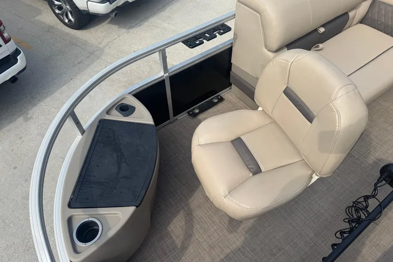 Slide: The Image of 2021 Sun Tracker Fishin' Barge 20 DLX interior with beige seating and fishing station. - 9