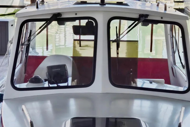 Slide: The Image of 2013 Atlas Boat Works Pompano 21 with Garmin navigation, docked in a marina. - 12