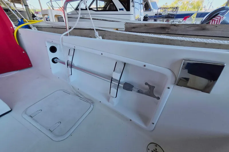 Slide: The Image of 2013 Atlas Boat Works Pompano 21 interior with storage compartment and deck features. - 14