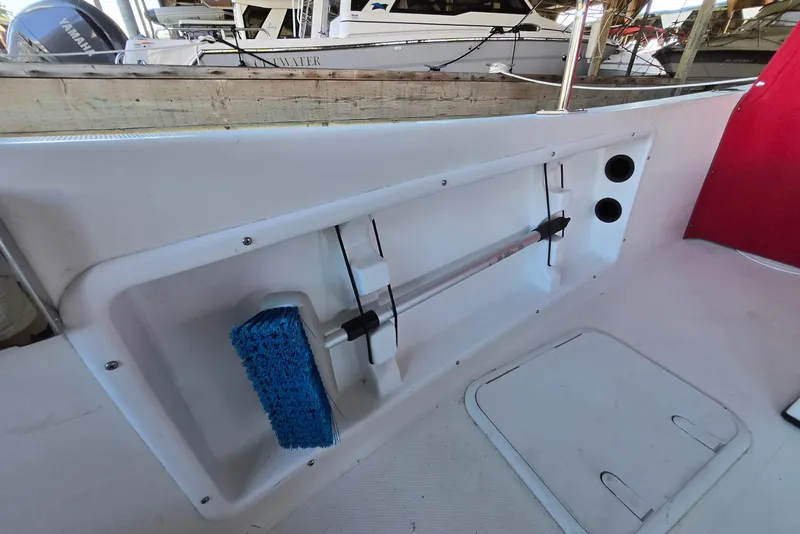 Slide: The Image of 2013 Atlas Boat Works Pompano 21 interior with storage compartment and cleaning brush. - 15