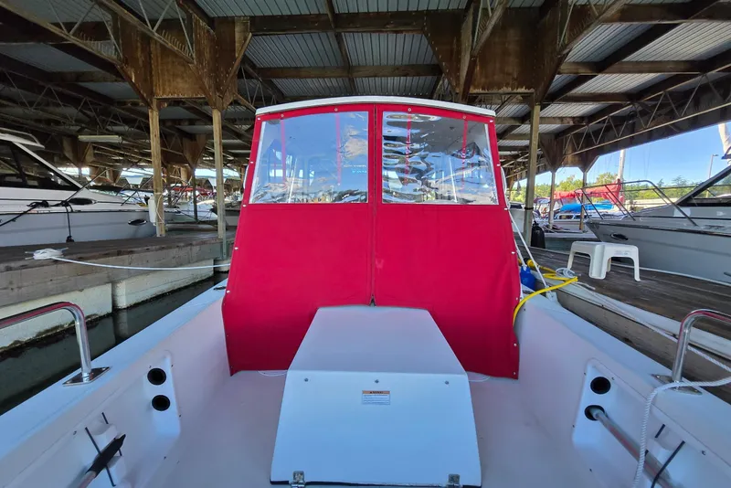 Slide: The Image of 2013 Atlas Boat Works Pompano 21 docked under a covered marina. - 22