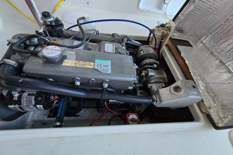 Slide: The Image of Engine compartment of 2013 Atlas Boat Works Pompano 21, showcasing detailed mechanical components. - 26