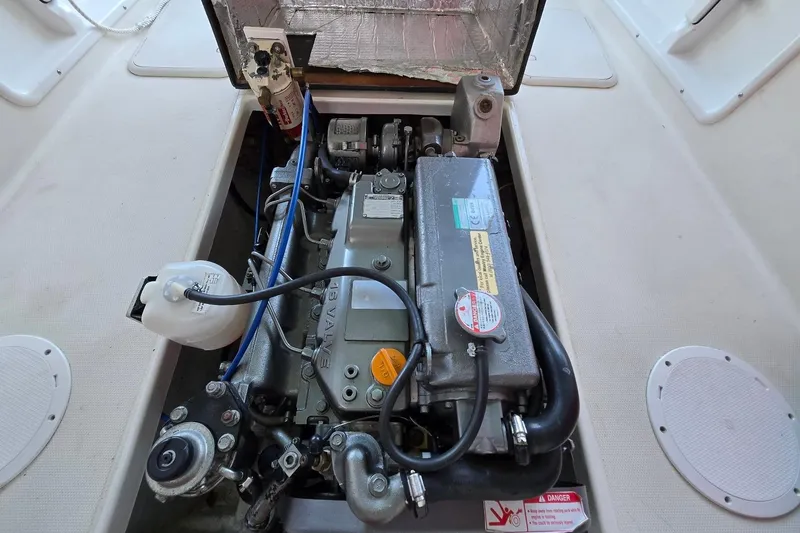 Slide: The Image of Engine compartment of a 2013 Atlas Boat Works Pompano 21, showcasing detailed mechanical components. - 27